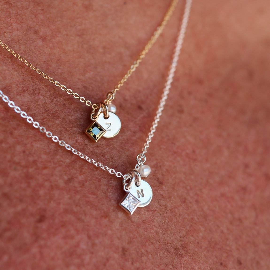 Necklace with birthstone pendants on a person's neck - KBN Jewellery - birthstone necklace - initial tiny pendant necklace