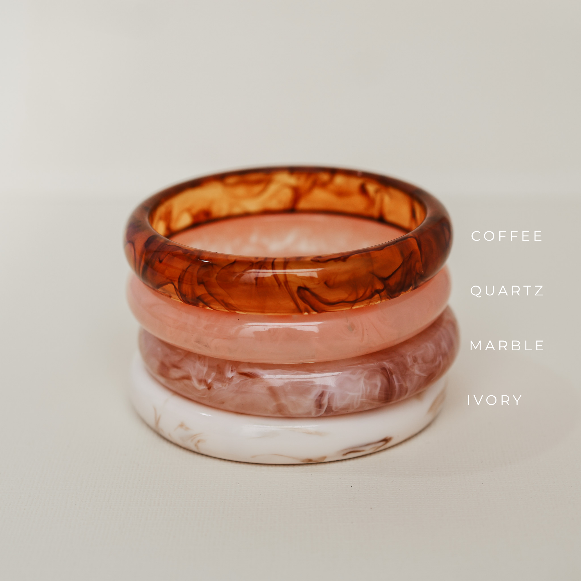 Stack of three tortoiseshell bangles on a light background - KBN RESIN BANGLES