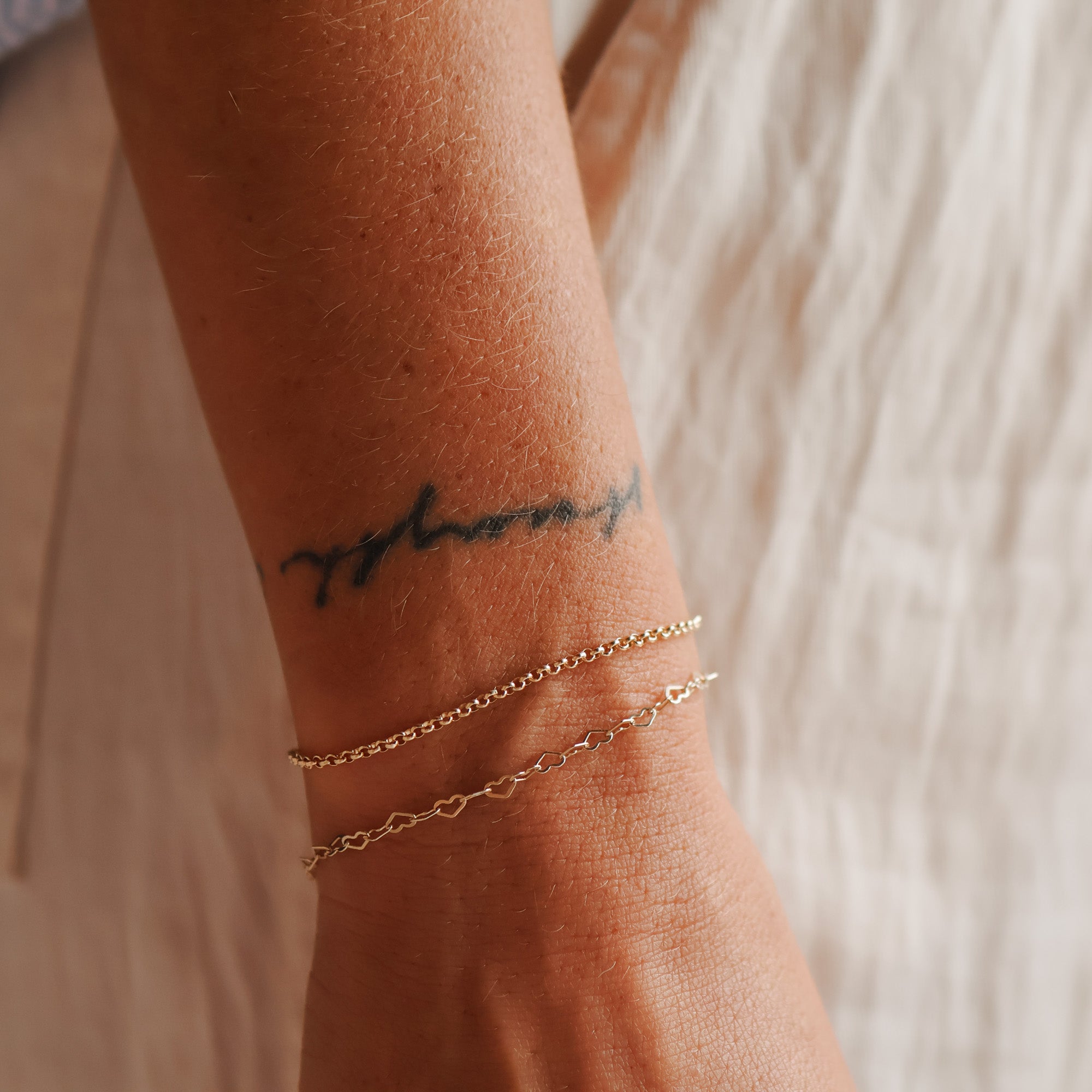 rolo bracelet, stacked bracelet worn on wrist featuring the rolo chain bracelet and a heart chain bracelet gold filled bracelet stacking bracelet