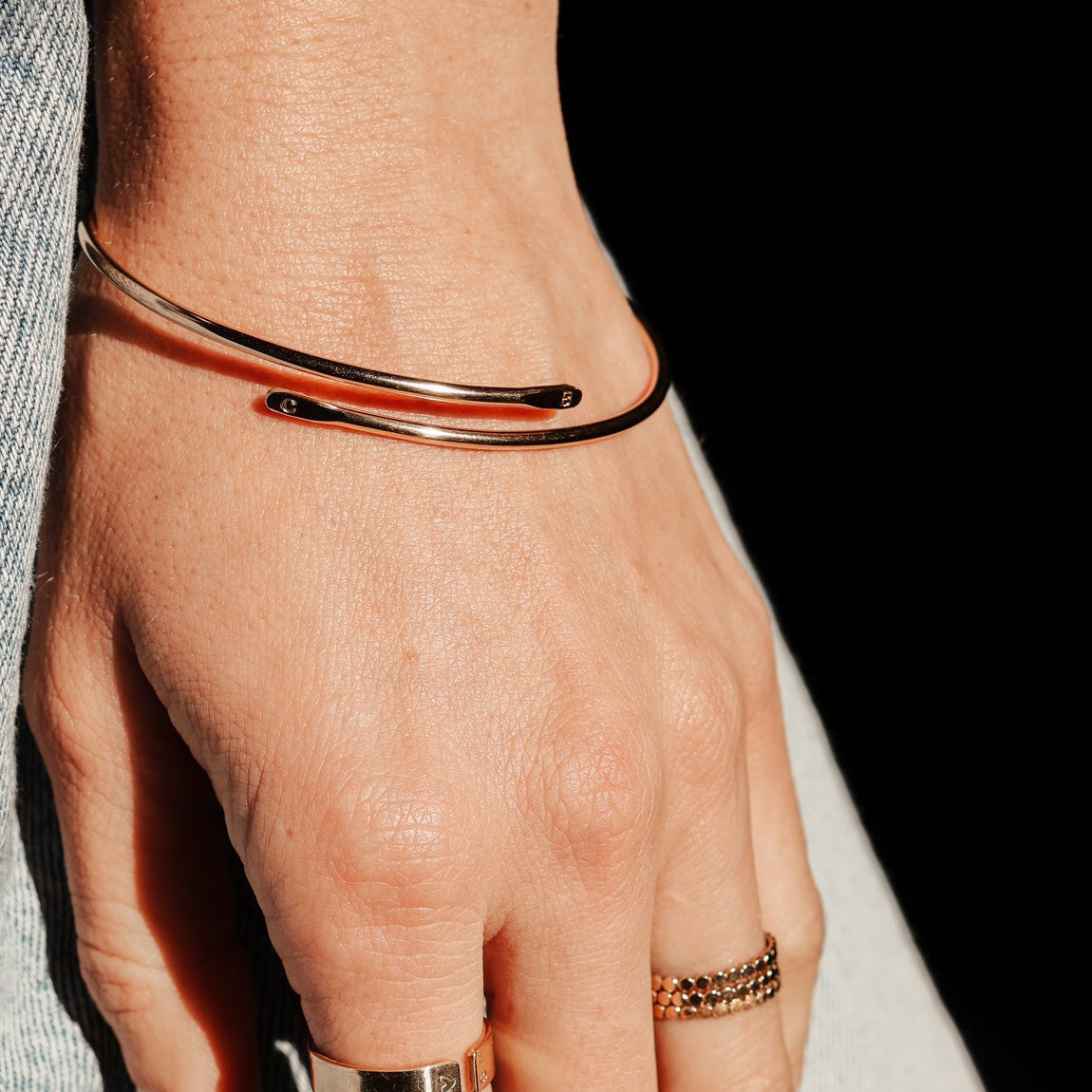 gold initial bangle being worn