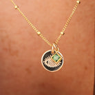 delicate gold satelite chain necklace with small evil eye pendant and a small square green birthstone accent. Brisbane personalised jewellery