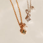 Two necklaces with square pendants on a light background - KBN Jewellery - Birthstone Necklace - Pearl Necklace