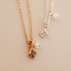 Two necklaces with square pendants on a light background - KBN Jewellery - Birthstone Necklace - Pearl Necklace
