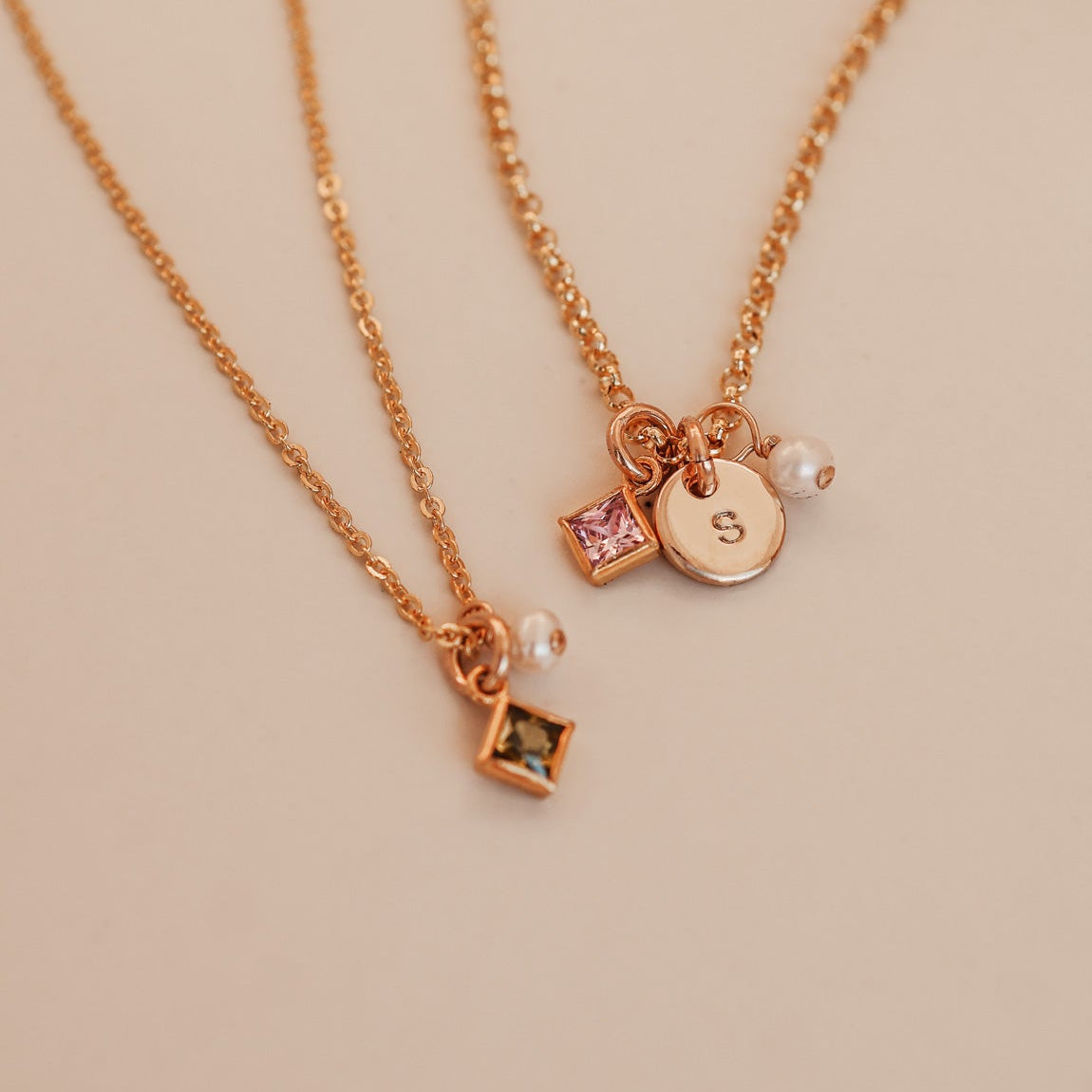 Two necklaces with square pendants on a light background - KBN Jewellery - Birthstone Necklace - Pearl Necklace